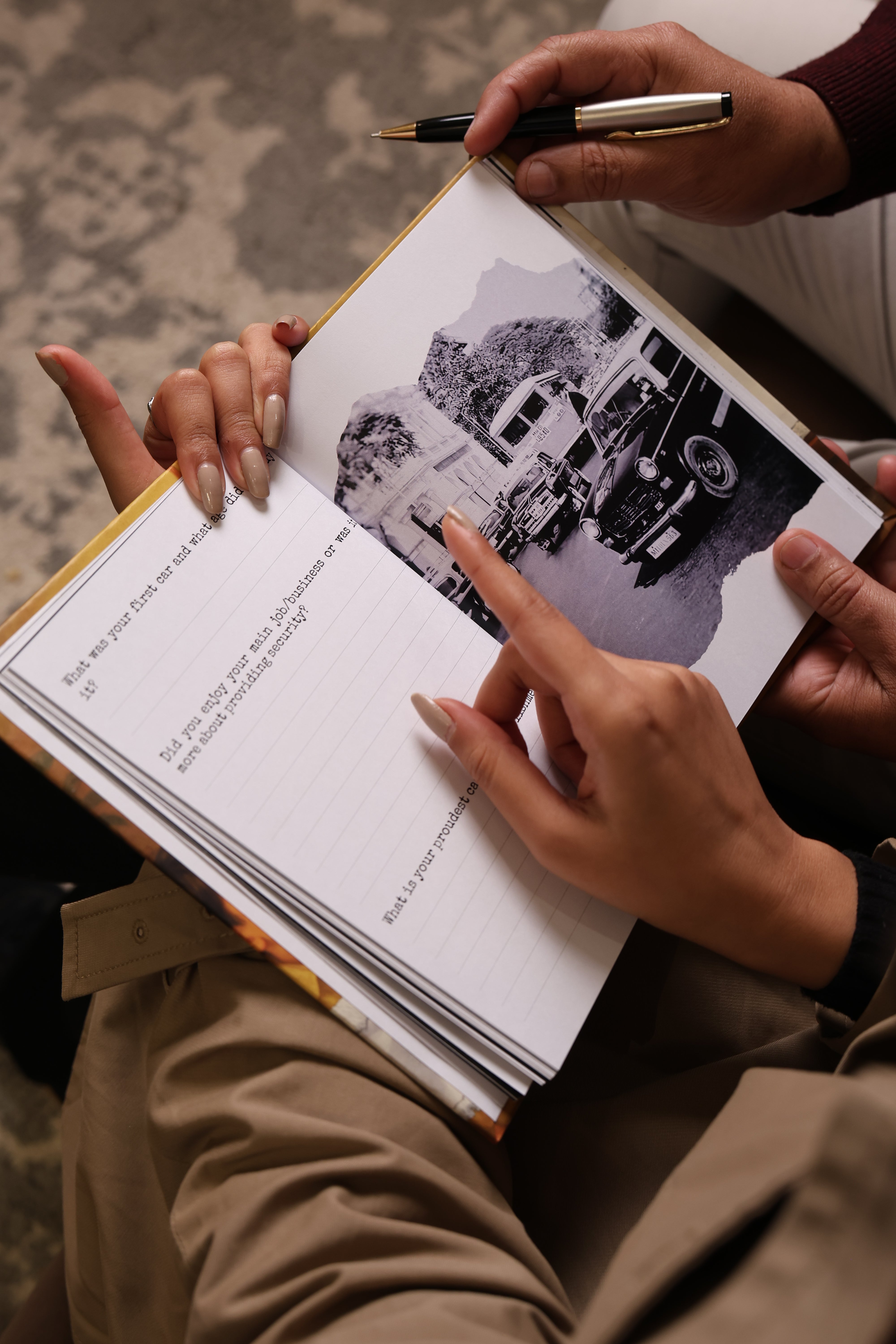 Open guided memory journal showing prompts and nostalgic black and white photo, Indian family heritage keepsake